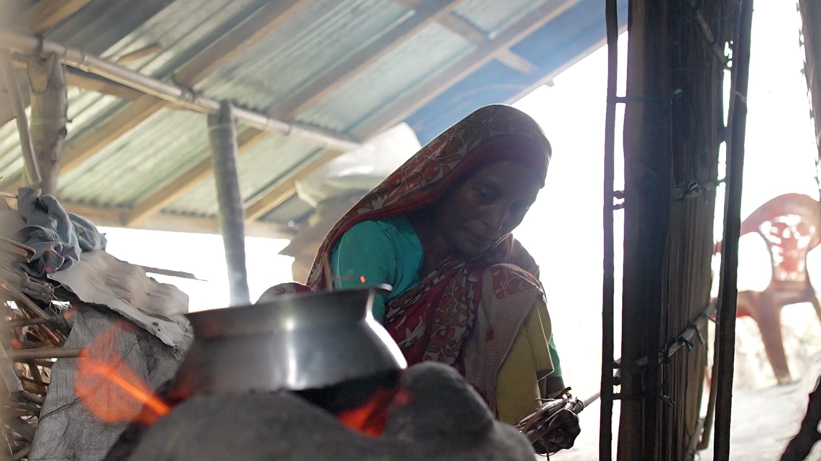 Meher Nigar on the open veranda of her home beside the Meghna